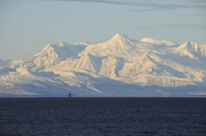 Cook Inlet with an oil rig and Mount Spurr in the background. Photo by DCSL, Creative Commons/Flickr.