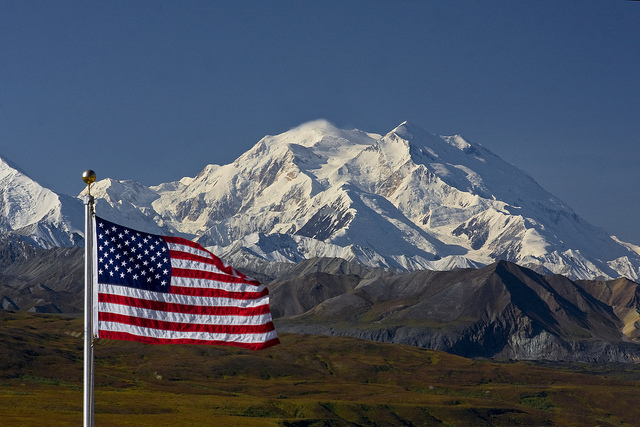 The National Parks are America's best idea. The iconic Denali with our flag. NPS photo by Ken Conger.