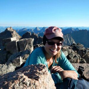 Kat sitting on top of Windom Peak, a fourteener in southwestern Colorado.