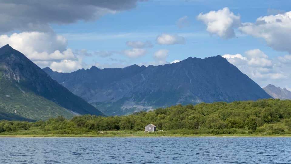 The family cabin on Togiak Lake with mountains behind it, water in front, blue skies above. Take care of the land and it will take care of you.
