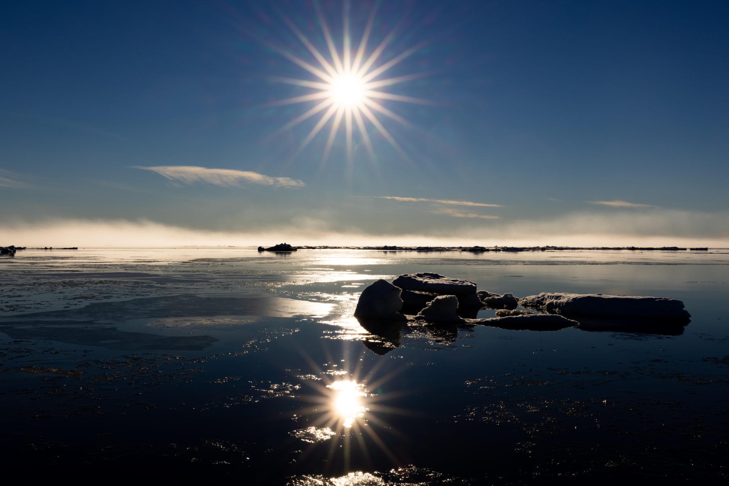 Sun over icy water